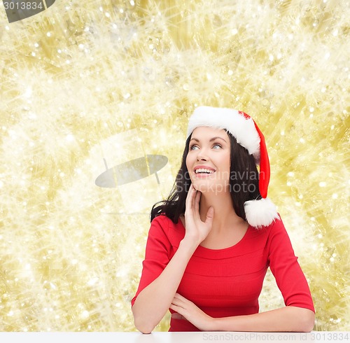 Image of smiling woman in santa helper hat