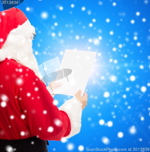 Image of man in costume of santa claus with letter