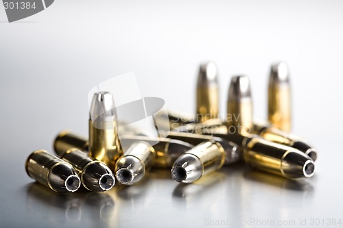 Image of bullets closeup on cold brushed metal