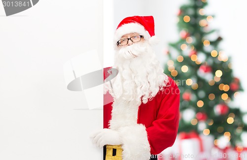 Image of man in costume of santa claus with billboard