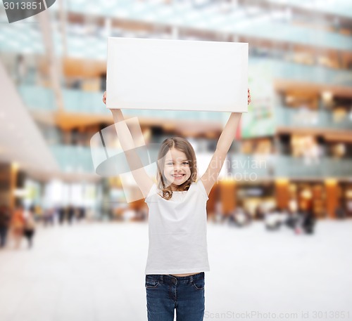 Image of smiling little girl holding blank white board