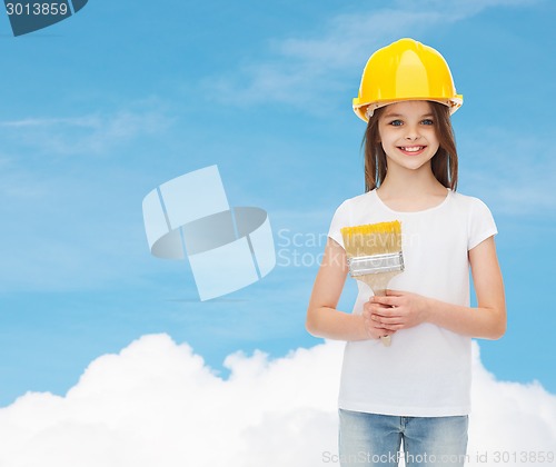 Image of smiling little girl in helmet with paint brush