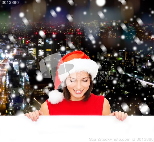Image of woman in santa helper hat with blank white board