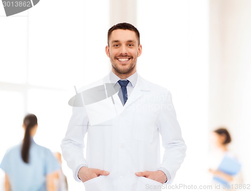 Image of smiling male doctor in white coat