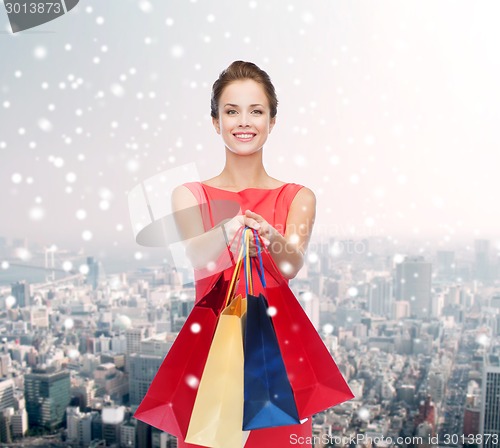 Image of smiling woman with colorful shopping bags