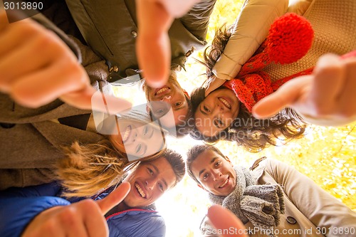 Image of group of smiling men and women in autumn park