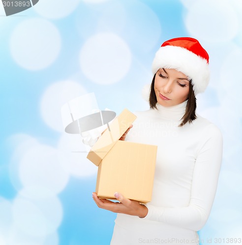 Image of woman in santa helper hat with gift box