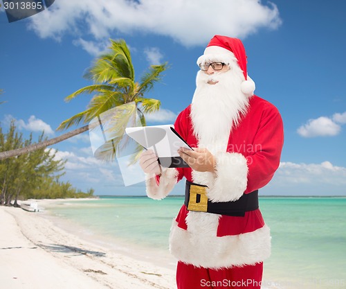 Image of man in costume of santa claus with notepad