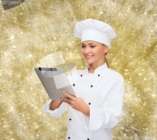 Image of smiling female chef with tablet pc computer