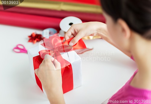 Image of close up of woman decorating christmas presents