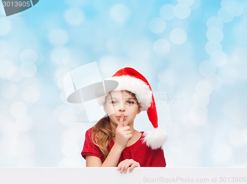 Image of smiling little girl in santa helper hat