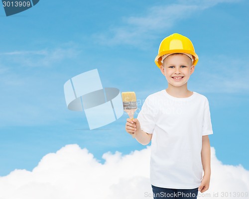 Image of smiling little boy in helmet with paint brush