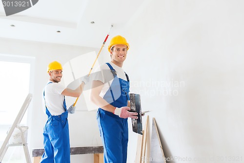 Image of group of builders with tools indoors