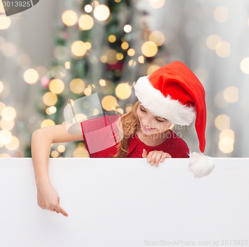 Image of girl in santa helper hat with blank white board