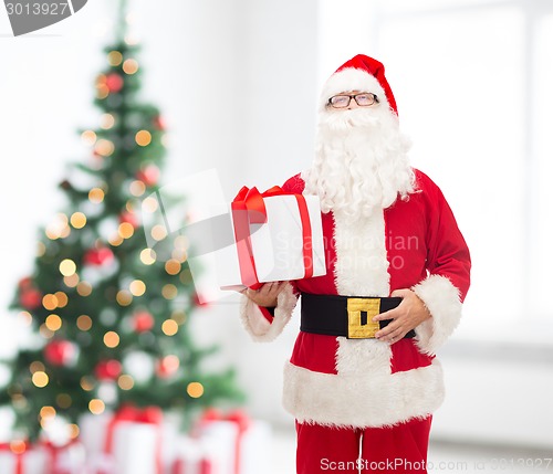 Image of man in costume of santa claus with gift box