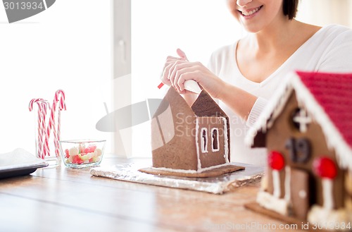 Image of close up of woman making gingerbread houses