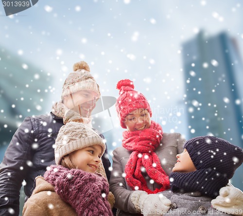 Image of happy family in winter clothes outdoors