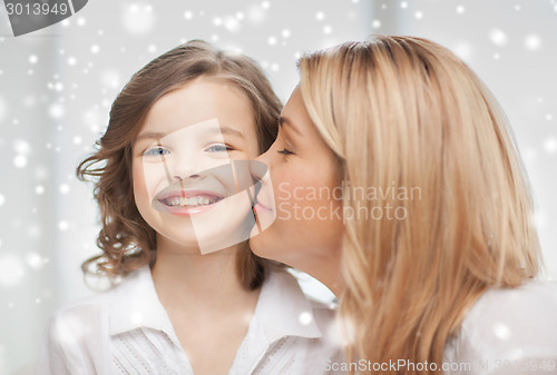 Image of happy mother and daughter cuddling