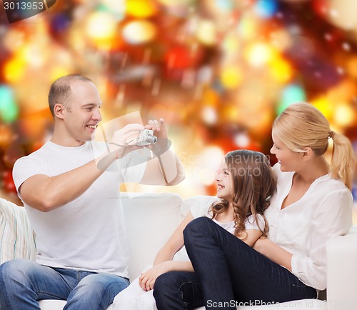 Image of happy family with camera at home