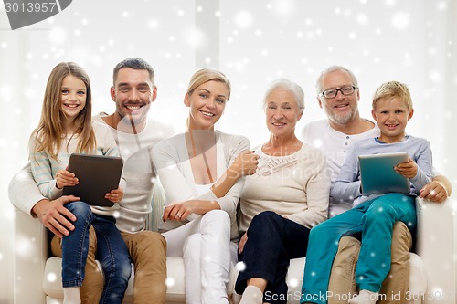 Image of smiling family with tablet pc computers at home