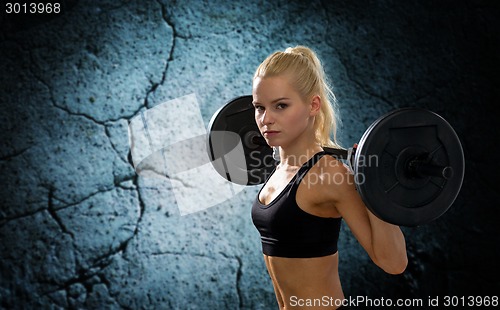 Image of sporty woman exercising with barbell