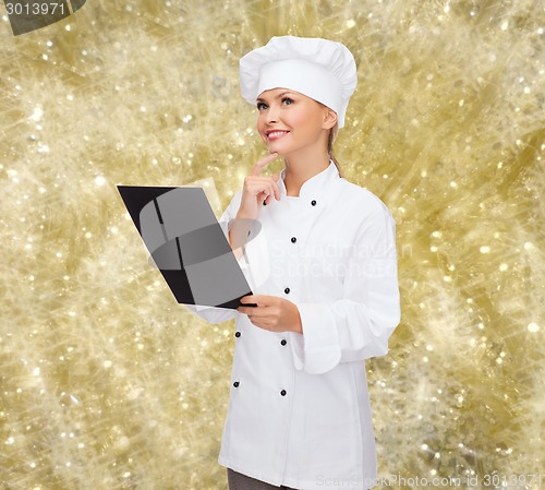 Image of smiling female chef with black blank paper