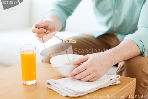 Image of close up of man eating breakfast at home