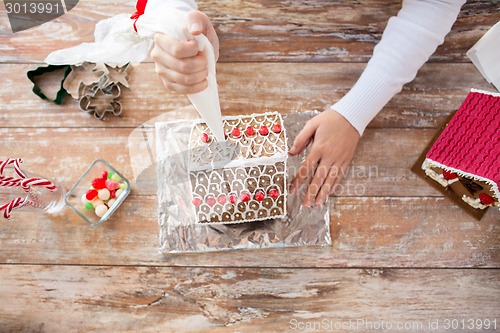 Image of close up of woman making gingerbread houses