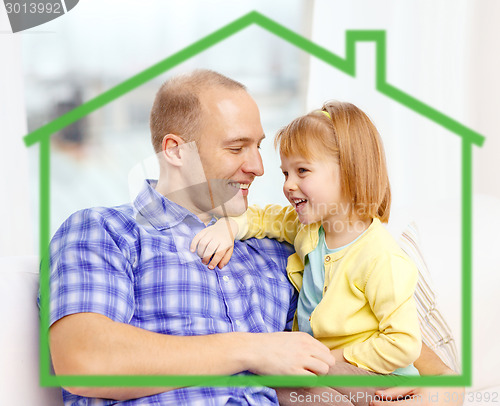 Image of smiling father and daughter together at home