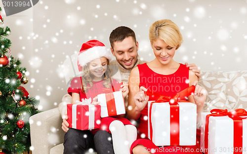 Image of smiling family holding many gift boxes