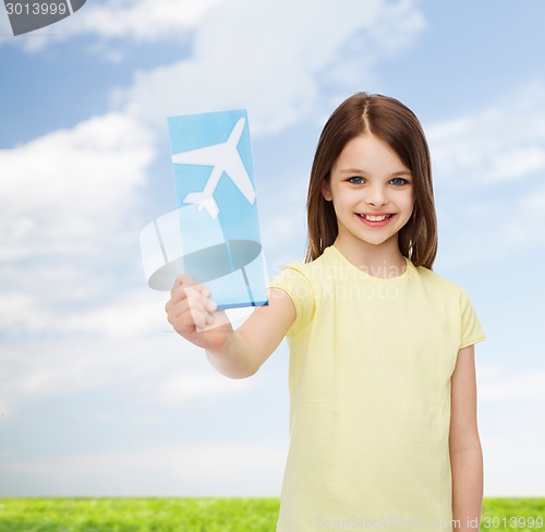 Image of smiling little girl with airplane ticket