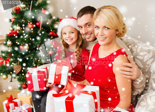 Image of smiling family holding many gift boxes