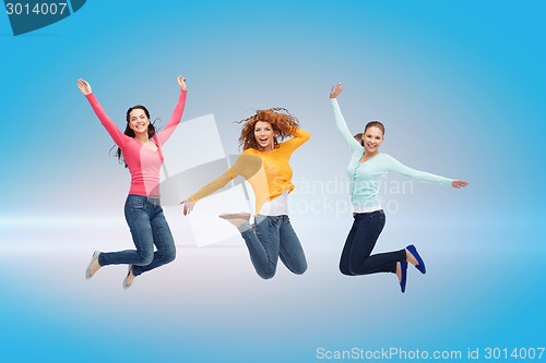 Image of smiling young women jumping in air