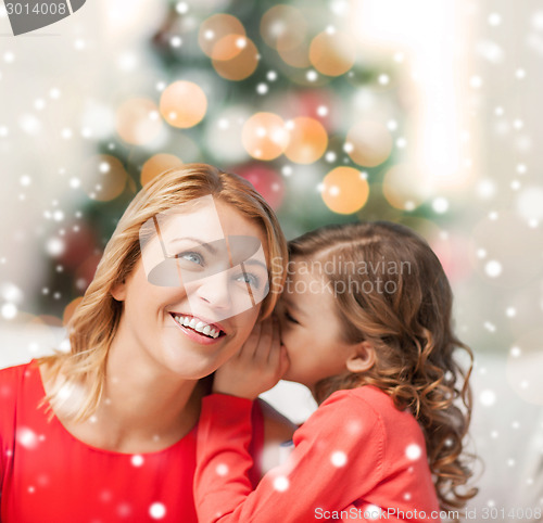 Image of happy mother and girl whispering into ear