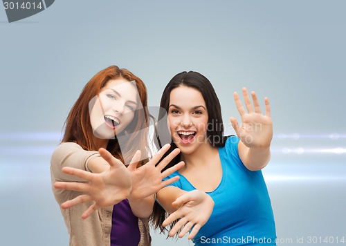 Image of smiling teenage girls having fun