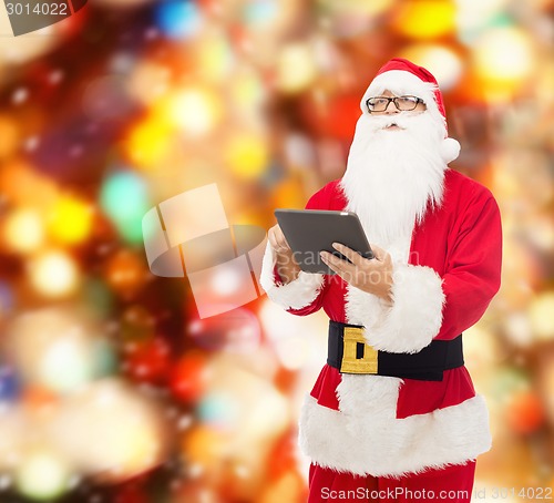 Image of man in costume of santa claus with tablet pc