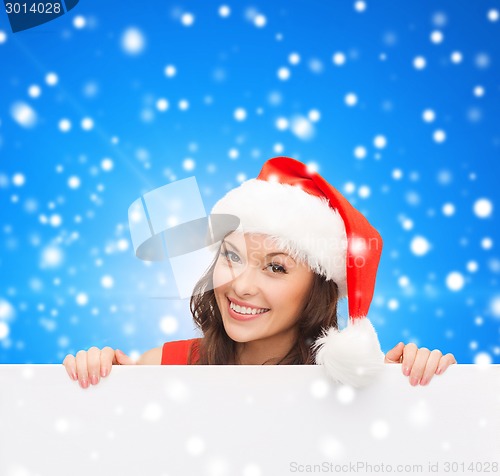 Image of woman in santa helper hat with blank white board