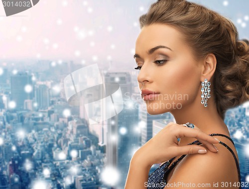 Image of beautiful woman wearing ring and earrings