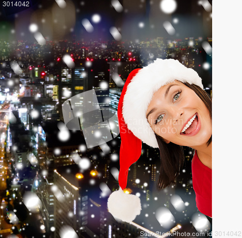 Image of woman in santa helper hat with blank white board