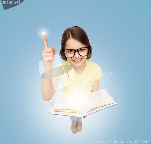 Image of smiling little girl in eyeglasses with book