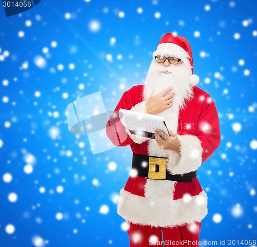 Image of man in costume of santa claus with notepad