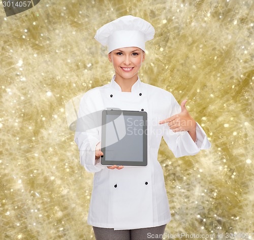 Image of smiling female chef with tablet pc blank screen