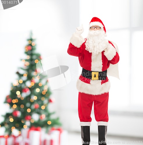 Image of man in costume of santa claus with bag