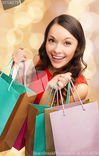 Image of smiling woman with colorful shopping bags