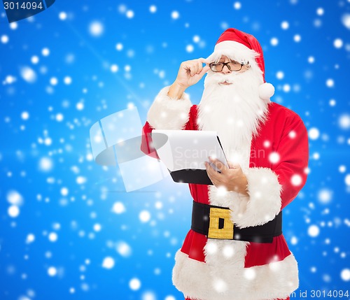 Image of man in costume of santa claus with notepad