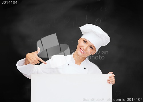 Image of smiling female chef with white blank board