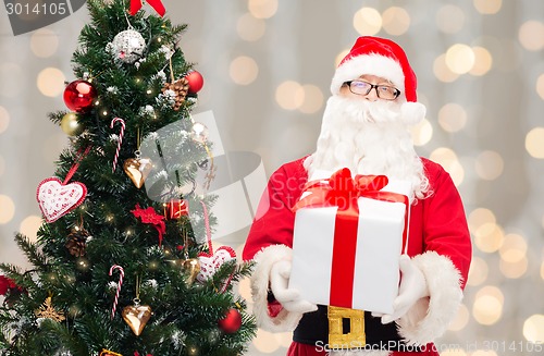 Image of man in costume of santa claus with gift box