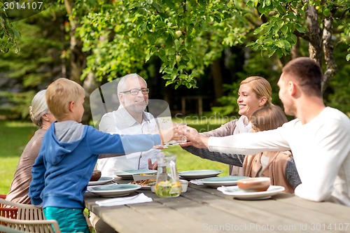 Image of happy family having holiday dinner outdoors