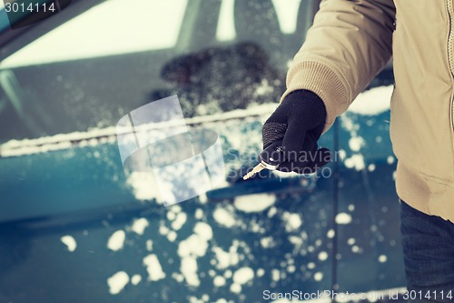 Image of closeup of man hand with car key outdoors