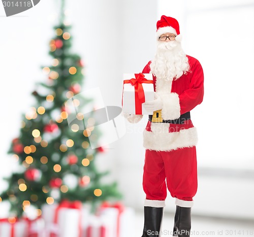 Image of man in costume of santa claus with gift box